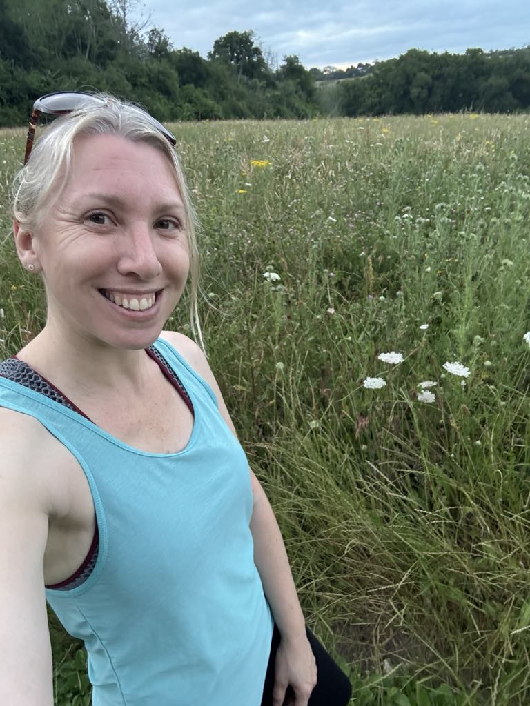 me enjoying the pretty wildflowers in a field