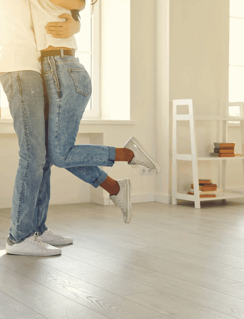 2 people in a new home with moving boxes around them