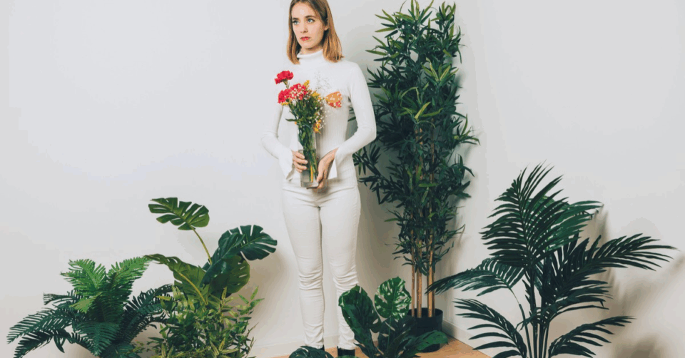 a lady stood with real and fake plants
