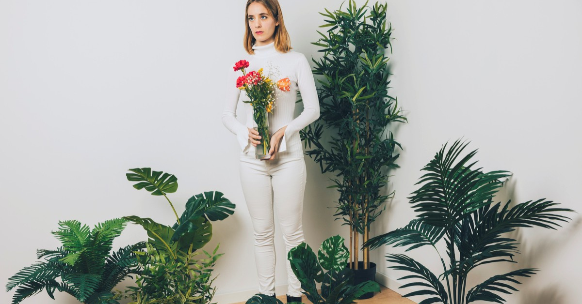 a lady stood with real and fake plants