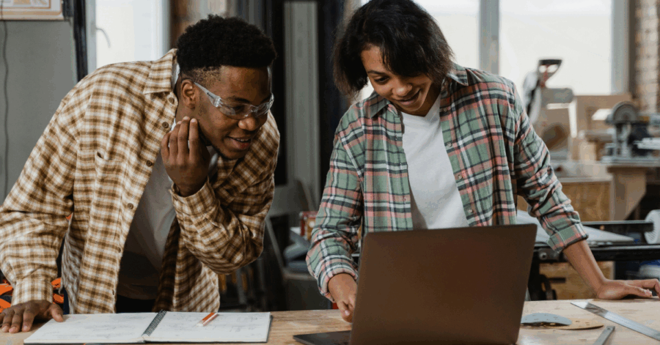 2 people looking at a laptop