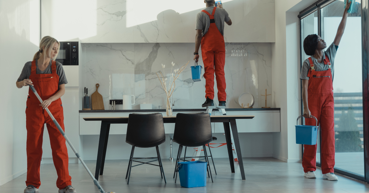 3 people cleaning at different levels in a room