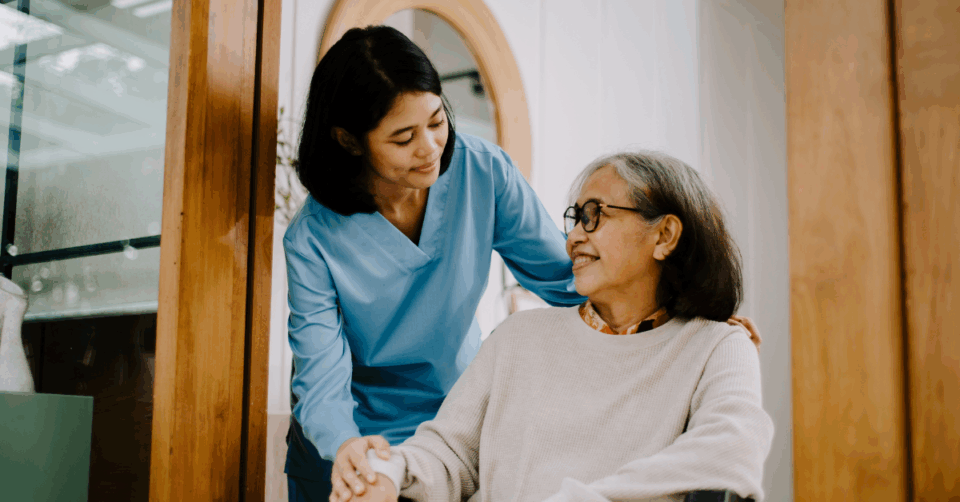 a woman caring for an older lady in a wheelchair
