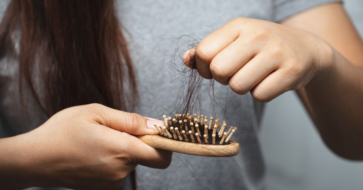 someone pulling hair out of a brush
