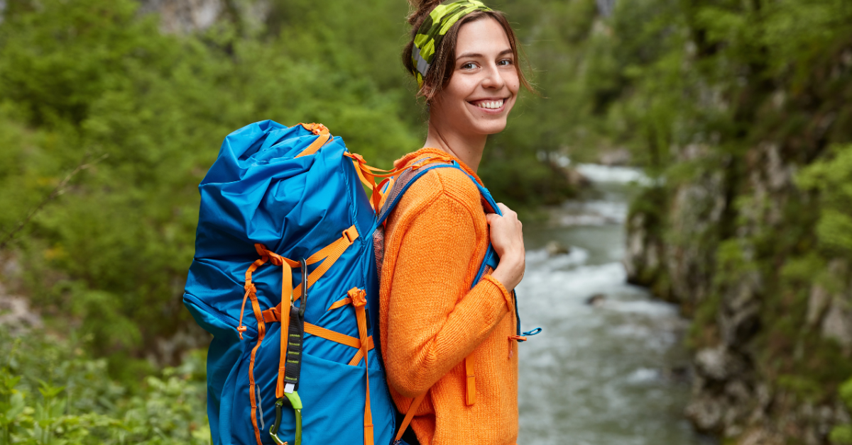 a lady hiking smiling