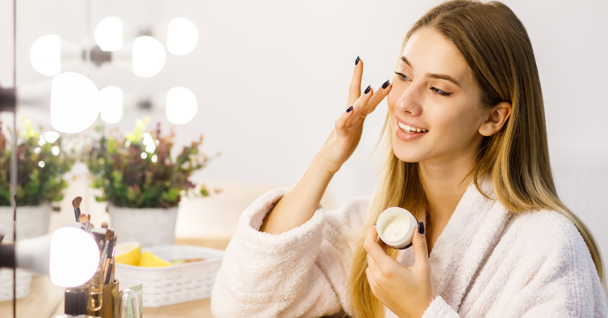 a woman putting on moisturiser