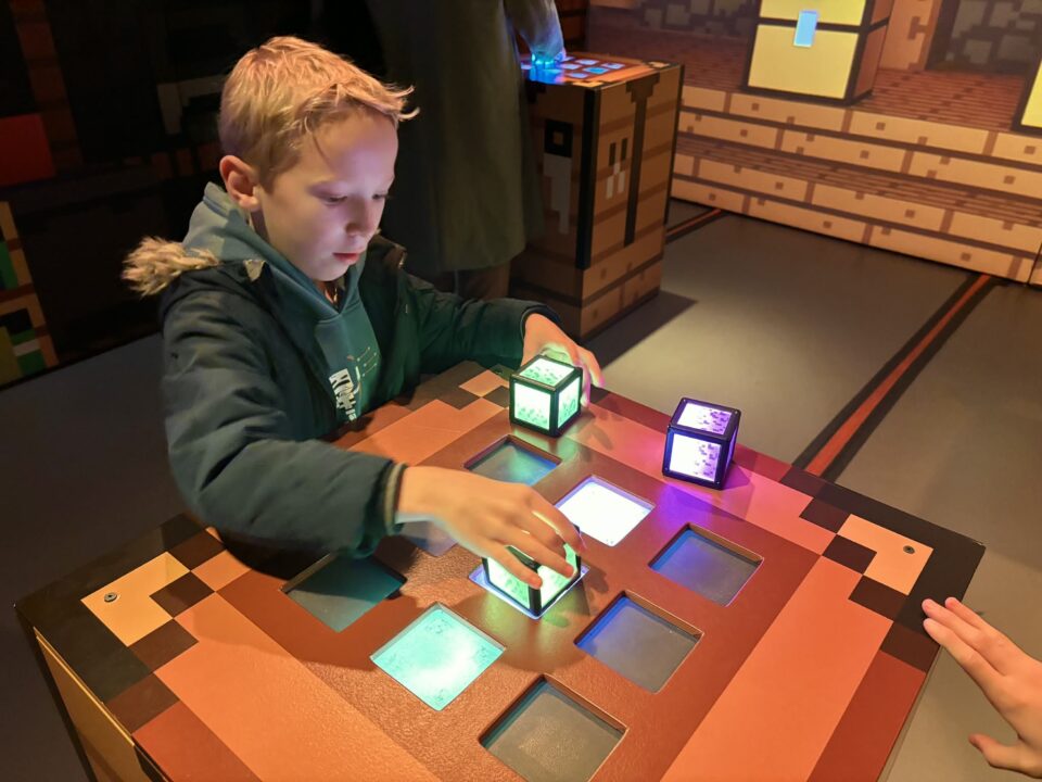 child playing in the Minecraft Experience using the orbs