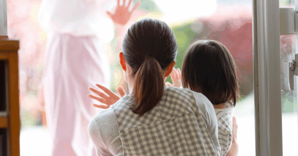 a woman and child waving someone off