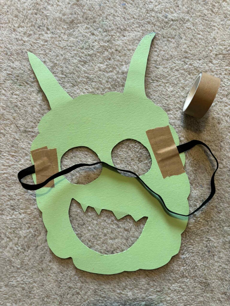 showing the tape and elastic on the back of the mask