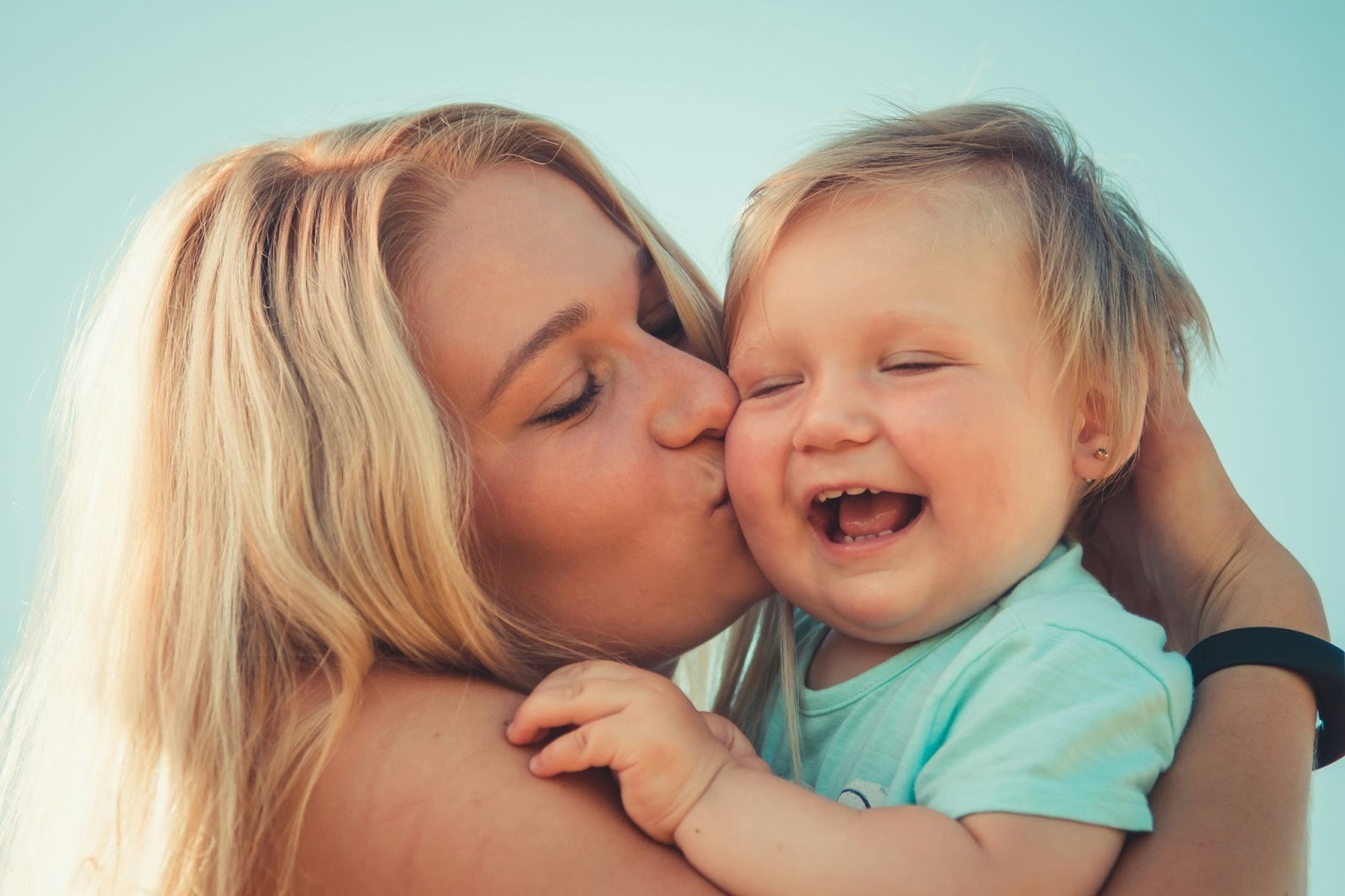 mum kissing a baby
