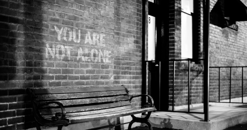 you are not alone written on a wall