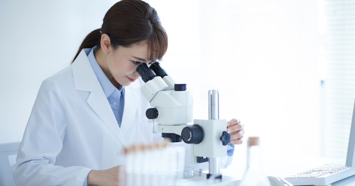 a scientist looking into a microscope