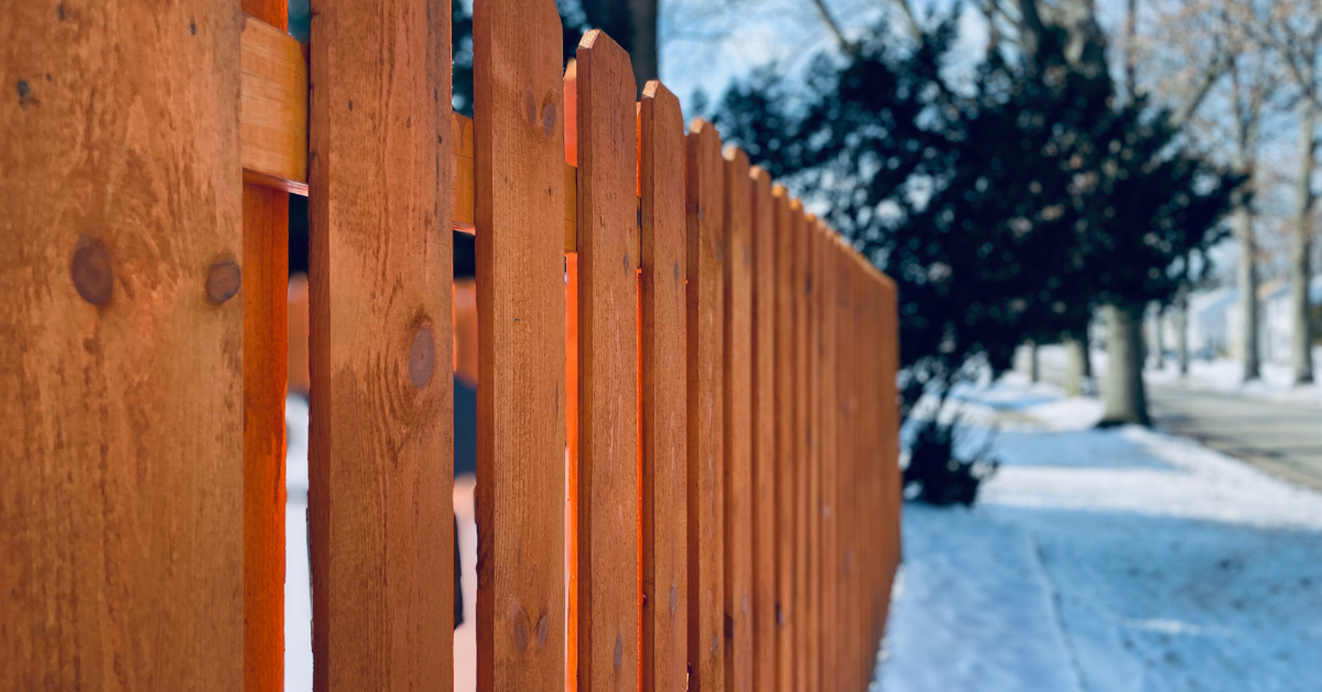a fence in a snowy town
