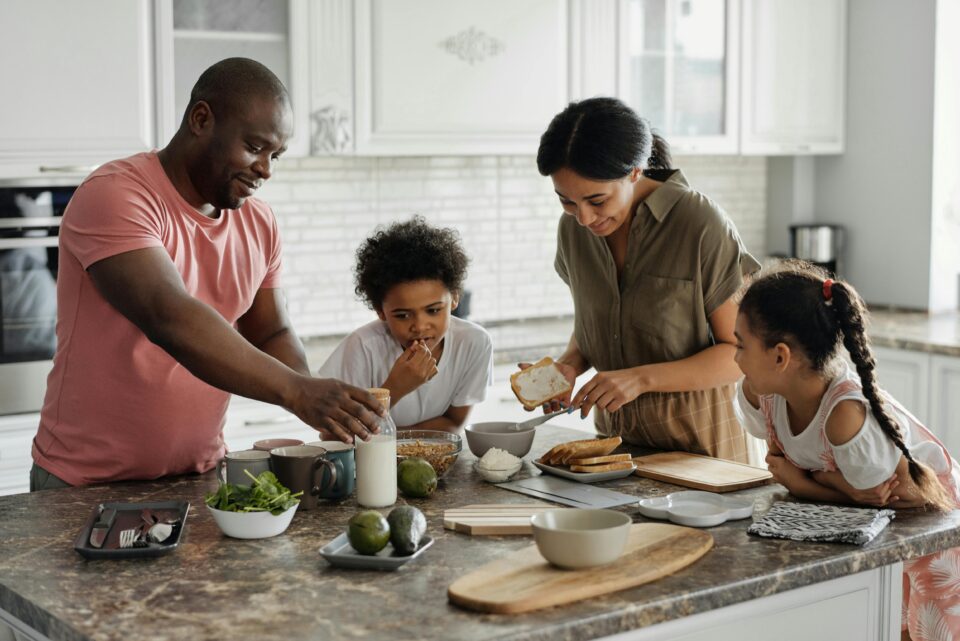 a family around an island in a kitchen
