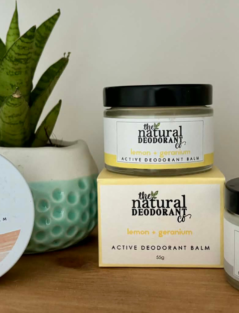 The Natural Deodorant co products on an oak shelf with an aloe plant