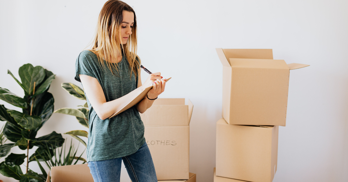 moving boxes and a woman list making