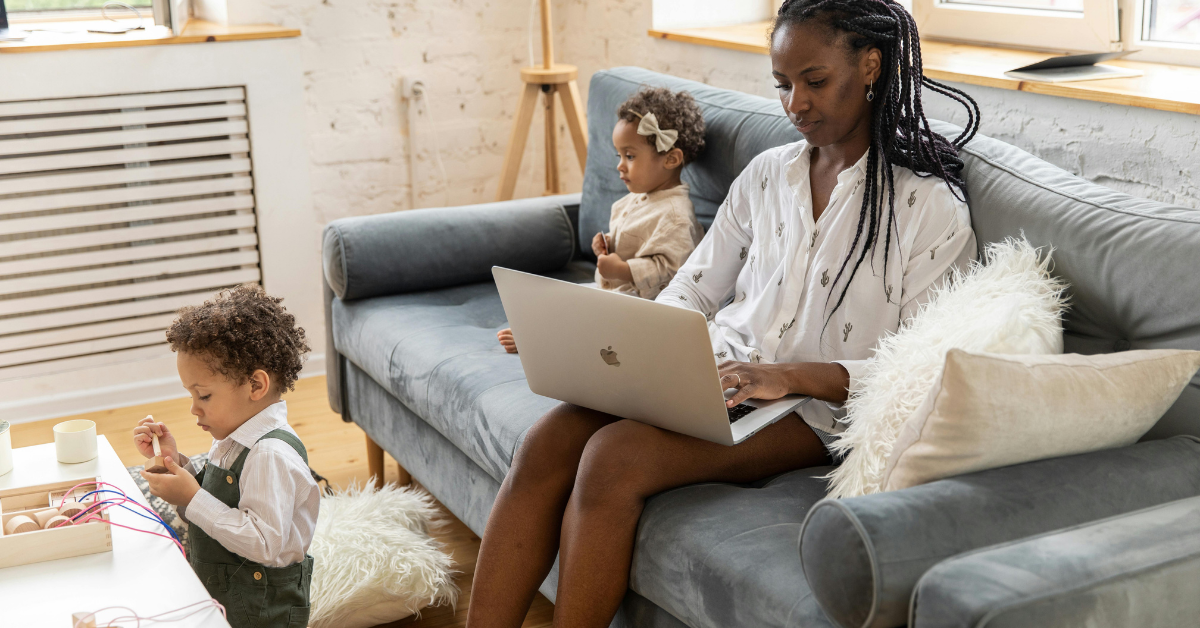 Mother working from home with children.