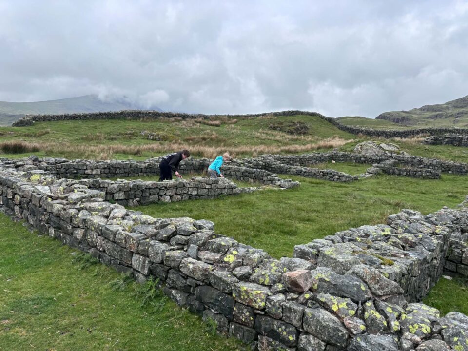 the kids looking at the ruins