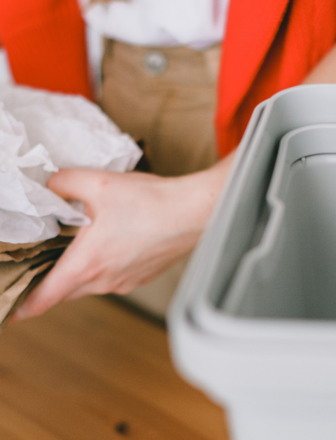someone holding paper for recycling to help to reduce waste