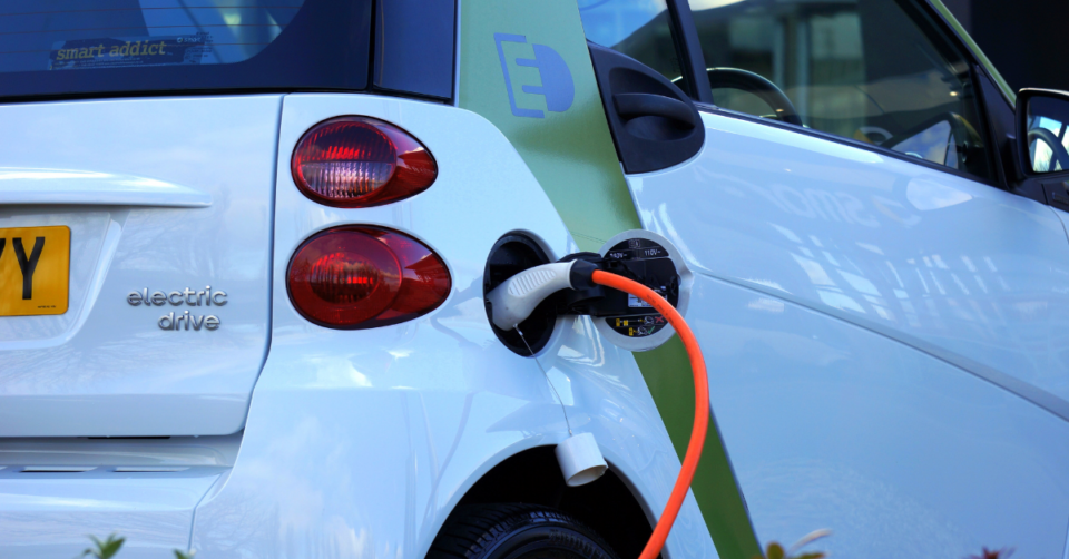 white electric car charging up