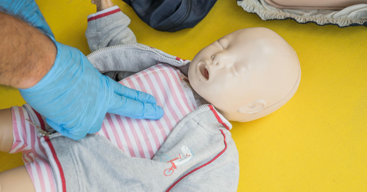 first aid training on a baby doll