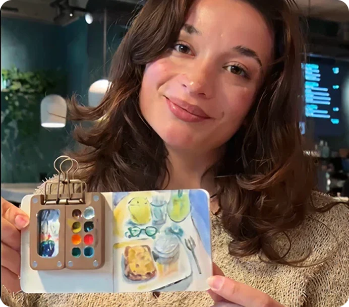 a lady holding up the watercolour learning kit