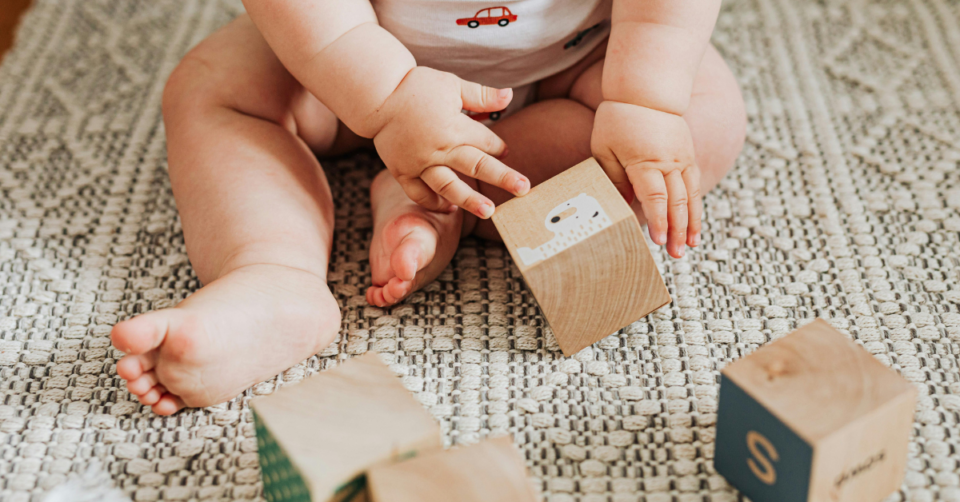 a baby playing with blocks