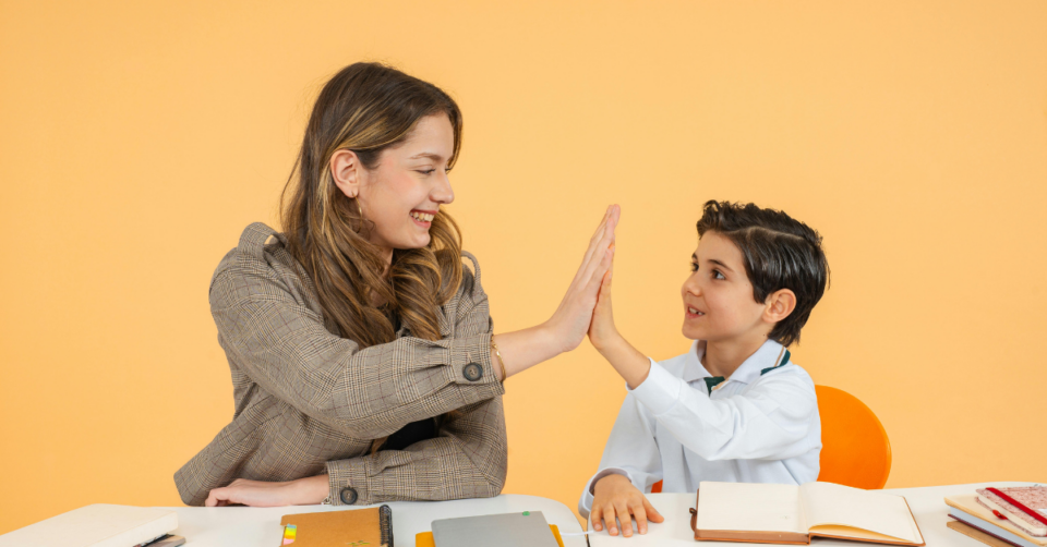 school support a teacher high fiving a child