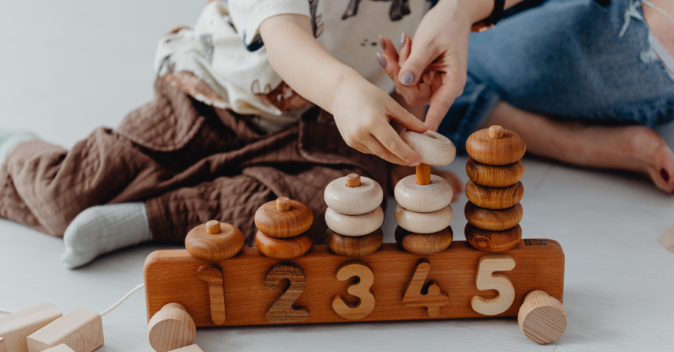 a wooden toy train being played with