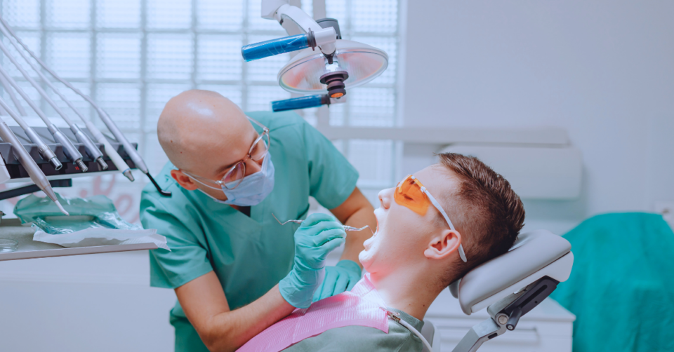 dentist seeing to someone in the chair