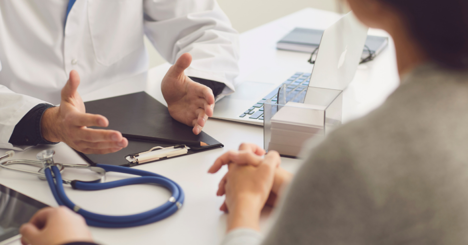 a woman sat with a doctor