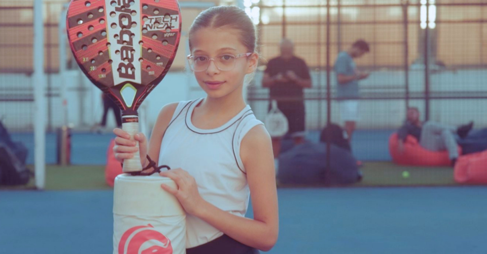a girl holding a tennis racket