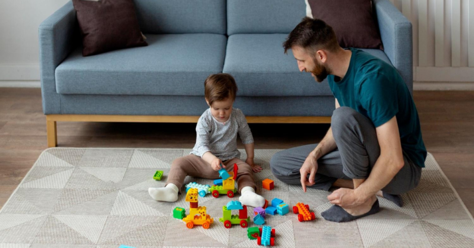 baby and dad on play mat