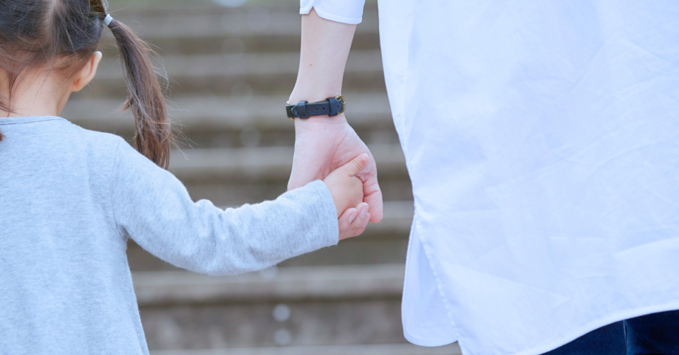 a child holding an adults hand