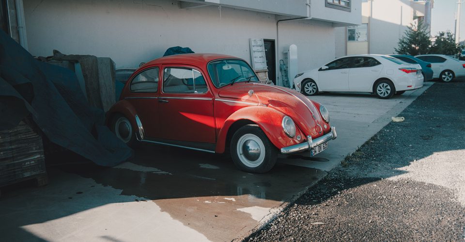Red VW beetle parked outside apartment in the UK