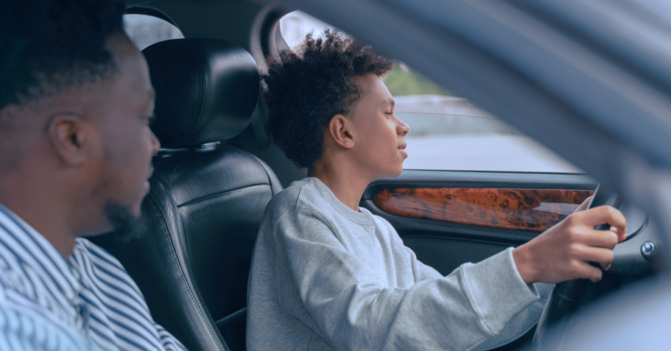 Proud father taking his son out for a drive in a newly bought car